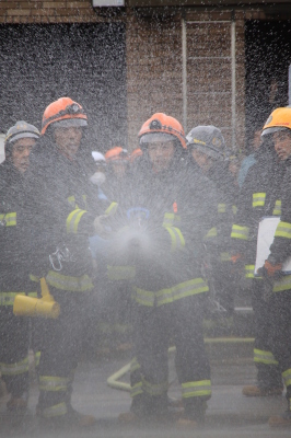 消防職員による大学の防火水そうを使用した消火活動の写真