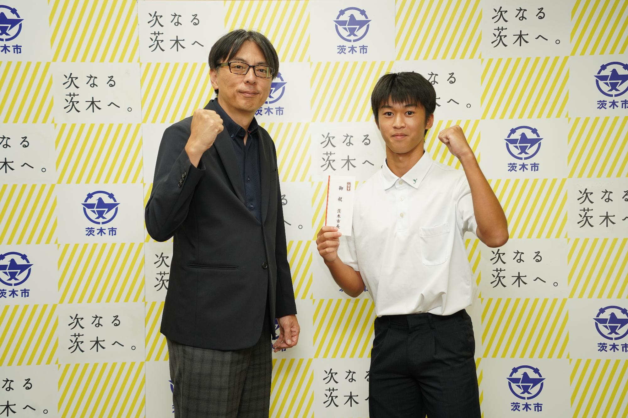 ガッツポーズをする井原悠晴さんと市長の写真