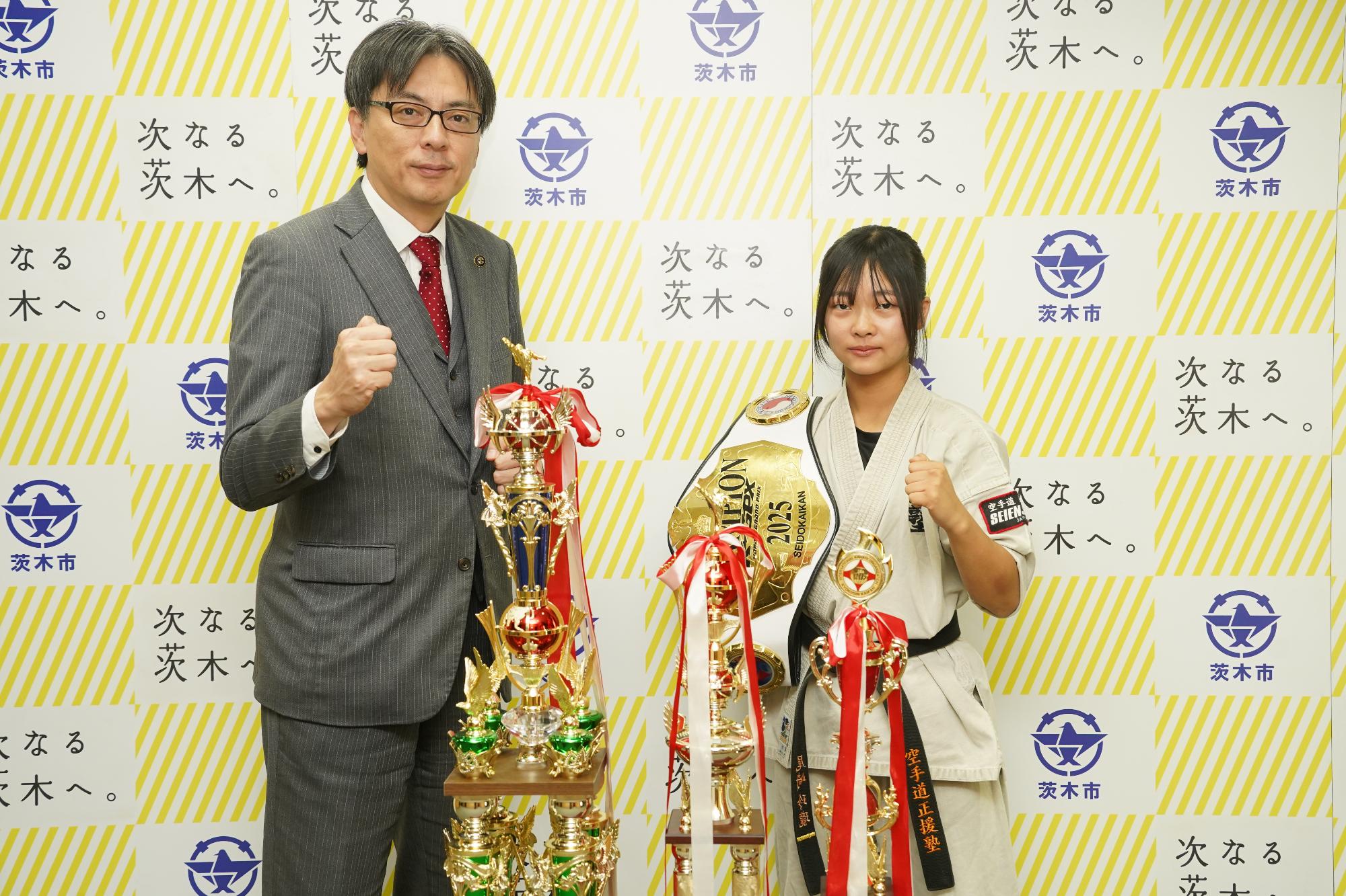 ガッツポーズをする選手と市長の写真