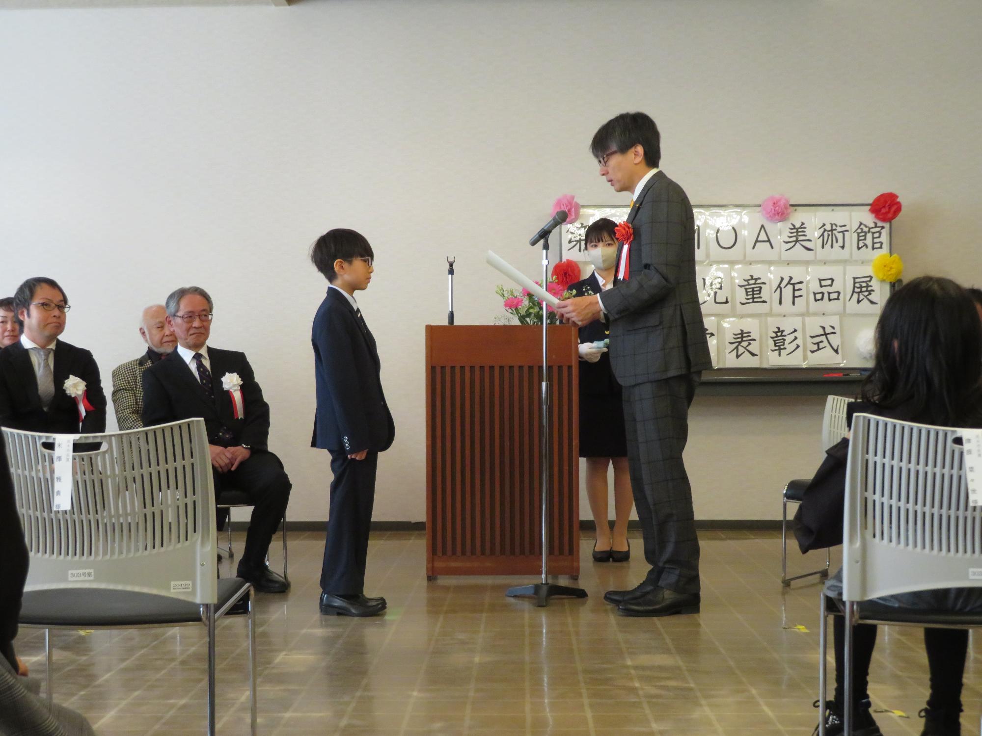 表彰状を授与する市長の写真