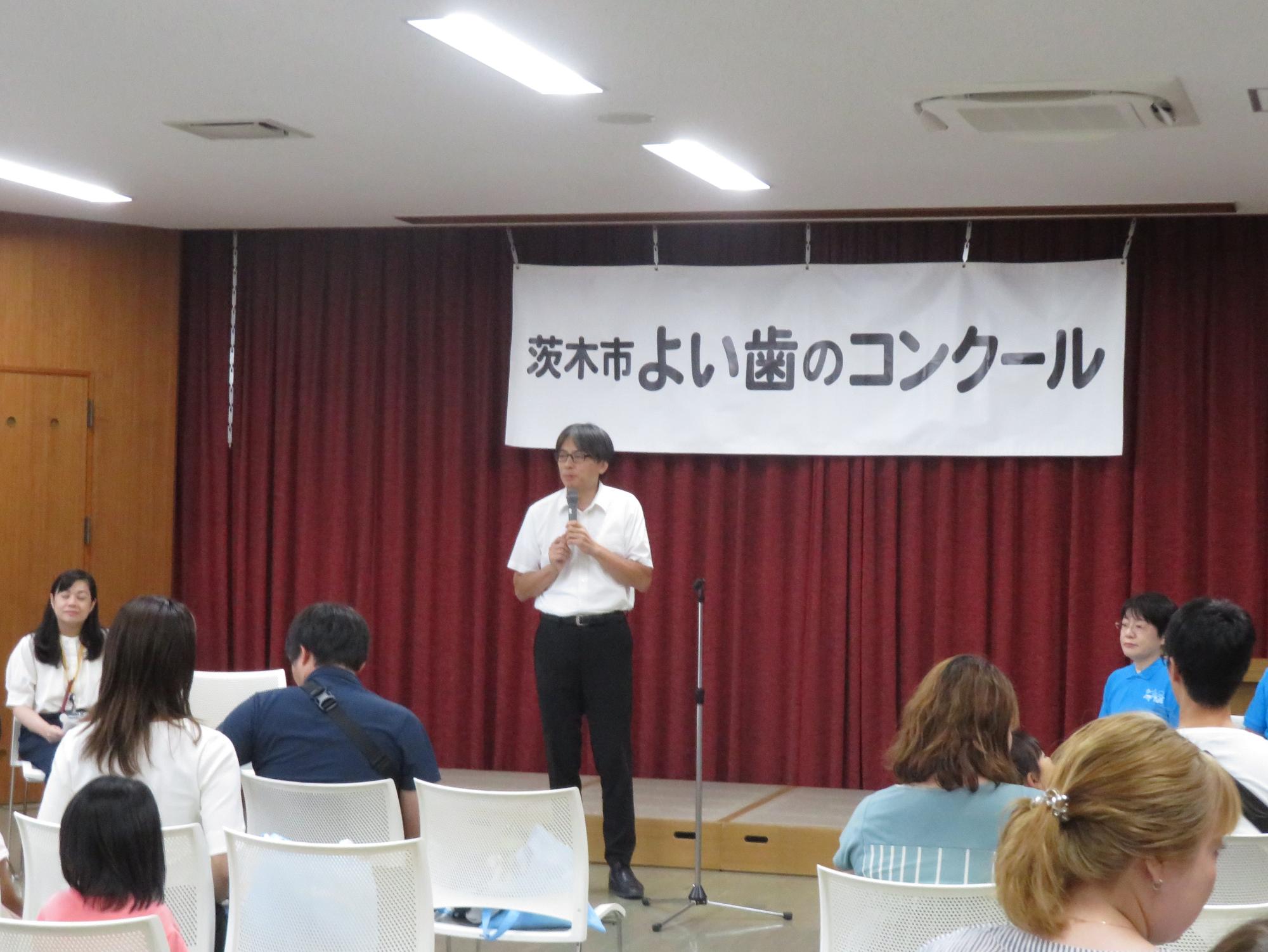 参加者の前であいさつをする市長の写真