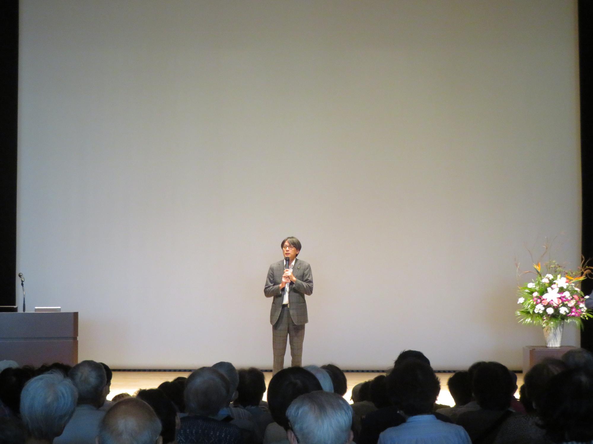 舞台上であいさつをする市長の写真